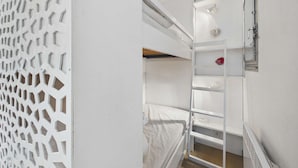A bunk bed room with a white ceiling, a white wall, and a white door. - Grau d'Agde: Studio cabin with terrace, private parking, sea view (Le Grau d'Agde)