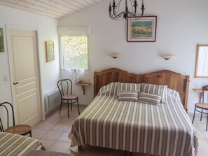 A bedroom with a bed, a chair, a window, and a picture on the wall. - "Comfortable Accessible Room with Private Bath, WiFi, TV, Baby Gear & Bicycles Near Blain" (Blain)
