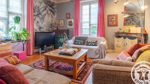 Una sala de estar acogedora con televisor, sofá y mesa de centro.