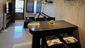 A modern kitchen with a dining area, a built-in refrigerator, and a large window with curtains. - One Oasis Condo 2 BR Near SM City Davao (Davao)