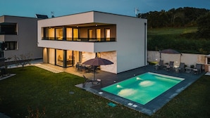 A modern two-story house with a swimming pool, outdoor seating, and a well-maintained lawn. - Beautiful Villa Angelina in Kastelir (Kastelir)