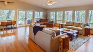 A spacious living room with a large sofa, a coffee table, and a dining area with a table and chairs. - 3.3k Sqft, Arcade, Views, EV, Pinecrest & Dodge Ridge (Twain Harte)