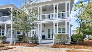 A two-story house with a porch, multiple windows, and a well-maintained lawn. - ⛵6-Seater Golf Cart🚙Beach + Nature Trails in 30A-Sail Away⛵ (Santa Rosa Beach)