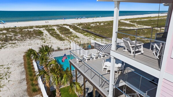A beachfront hotel with a pool, beach view, and outdoor seating. - Pinkies Up: Stunning MB Home- 4BR, Beachfront, Private Pool, Pet Friendly, Amazi (Mexico Beach)