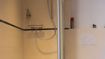 Shower, hair dryer, towels, toilet paper