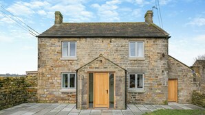 A stone house with a central door, two windows on the upper floor, and a stone wall to the left. - 2 bedroom accommodation in Risplith, near Ripon (Risplith, near Ripon)