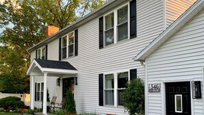 A two-story white house with black shutters, a front porch, and a fire department number sign. - SEE SOLAR ECLIPSE IN CTR OF PATH AT A BEAUTIFUL LAKEFRONT HOME.  NO CITY LIGHTS! (Cayuga)