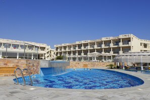 Enjoy a refreshing swim in the hotel's central pool surrounded by a spacious deck.