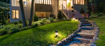 Luxurious midcentury modern glass house in the woods, chefs kitchen & great art 