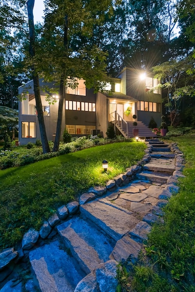 Luxurious midcentury modern glass house in the woods, chefs kitchen & great art 