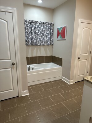 A bathroom with a bathtub, a shower, and a toilet.