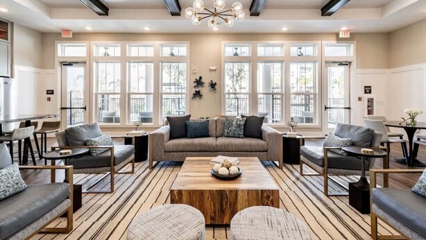 A spacious lounge area with a sofa set, coffee table, and seating arrangements. - Boho Chic Luxury Retreat Minutes to Theme Parks, Restaurants and Entertainment. (Kissimmee)