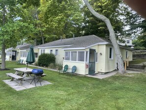Outdoor dining - Cottage 3 is a charming 2 bedroom 25’ from your boat dock & Hamlin lake. (Ludington)