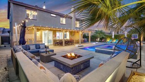 A modern house with a pool, outdoor seating, and a fire pit. - Coachella Escape. Brand New Luxury home in gated community. (Indio)