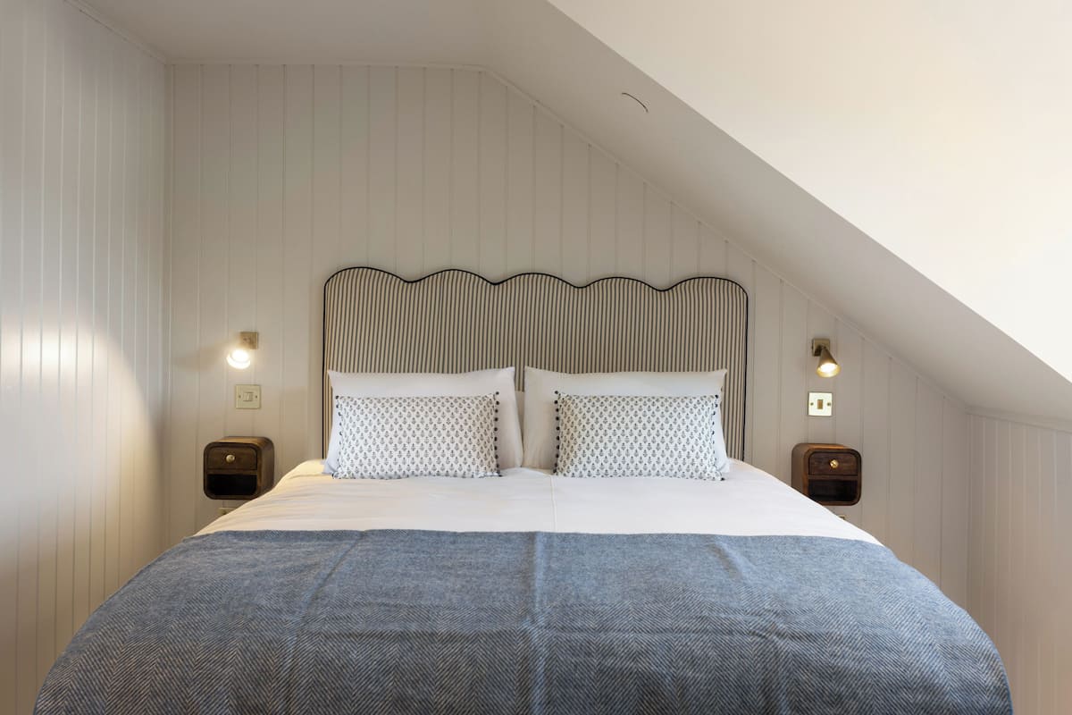 Premium bedding, memory-foam beds, laptop workspace, blackout curtains