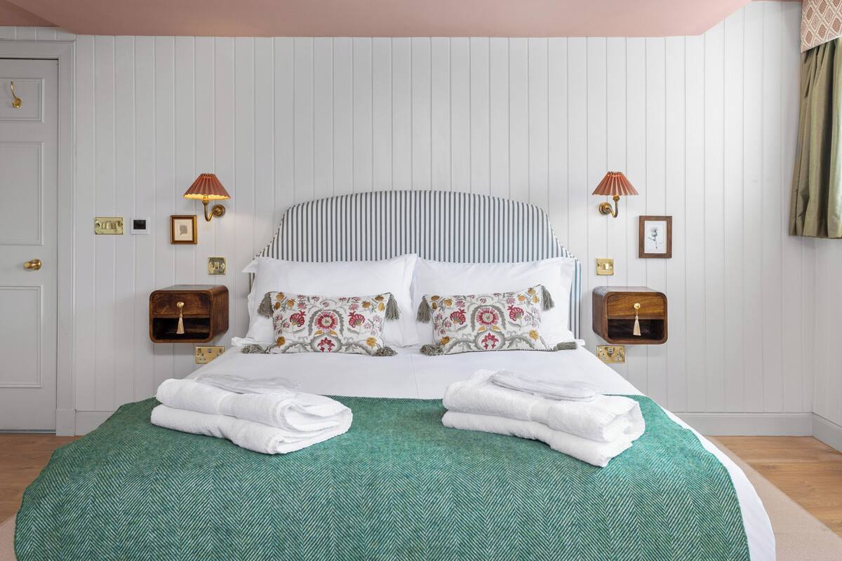 Premium bedding, memory-foam beds, laptop workspace, blackout curtains