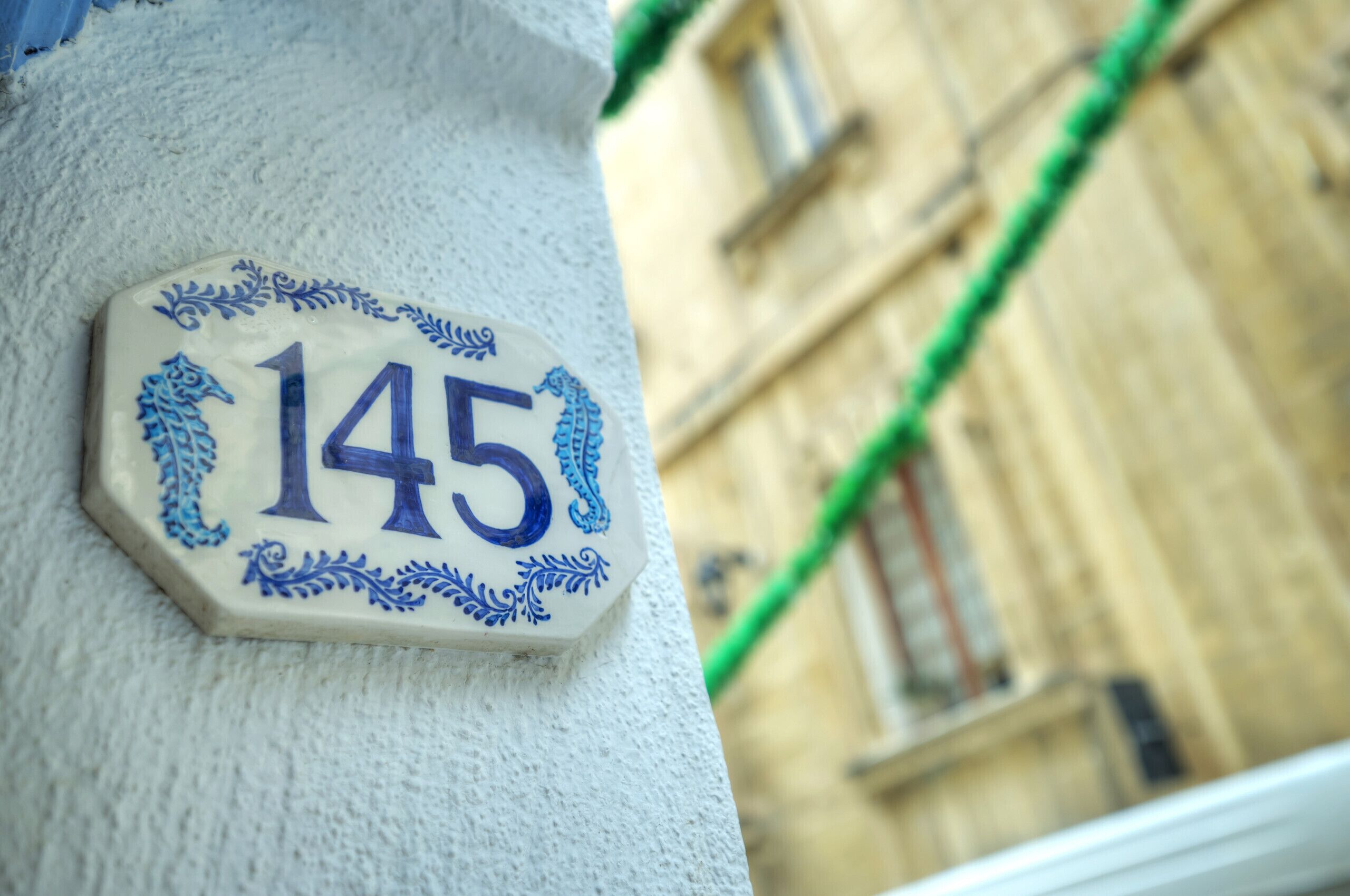 Una targa con il numero civico su un angolo di edificio.