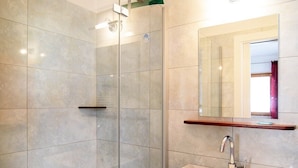 A modern bathroom with a glass shower enclosure, a white sink, and a mirror above it. - Studio Apartment 'Peter Paul  Penegal' with Mountain View and Shared Terrace (Eppan an der Weinstrasse)