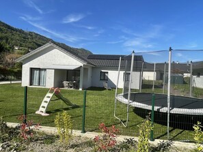 Enjoy a home away from home in this two-story house with a covered patio and backyard featuring a trampoline.