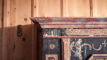 A wooden cabinet with a distressed finish and decorative elements.
