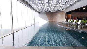 Indoor pool, open 8:00 AM to 9:00 PM, pool loungers