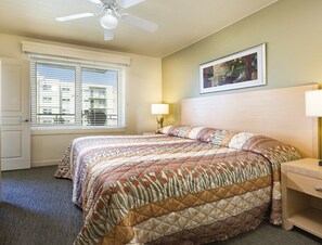 A hotel room with a bed, a nightstand, a lamp, a ceiling fan, and a window with blinds. - Seaside!! Condo with ocean view, grill on balcony, beach access from the resort. (Seaside)