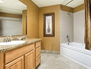 A bathroom with a wooden vanity, a sink, a bathtub, and a shower. - Seaside!! Condo with ocean view, grill on balcony, beach access from the resort. (Seaside)