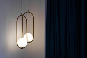 Deux suspensions avec des abat-jour sphériques sont suspendues au plafond.