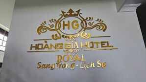 A hotel sign with the name "HOANG GIA HOTEL" and "ROYAL Sang Trang - Lich Su" in gold lettering. - Hoàng Gia Hotel Royal (Le Ho)
