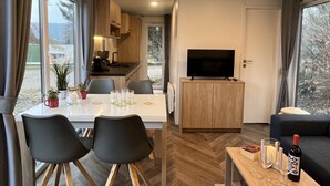 A modern interior with a dining area, kitchen, and living space. - Tiny Haus Antonia by Interhome (Riedenburg)
