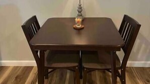 A dining table with four chairs, a lamp, and a fruit bowl on the table. - Cozy Apartment located on our 5-acre property (Winchester)