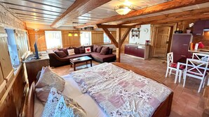 A cozy room with a bed, a sofa, and a dining area. - Vacation home Selma by Interhome (Grossschönau)