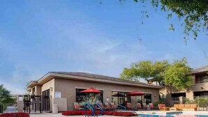 A swimming pool with lounge chairs and umbrellas, surrounded by a building with a flat roof and a gated entrance. - 2Bedroom/2Bath North Scottsdale Condo w/Amentities.

 (Scottsdale)