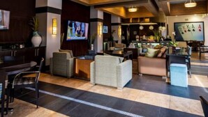 A spacious lobby with a bar area, comfortable seating, and a television screen. - 2Bedroom/2Bath North Scottsdale Condo w/Amentities.

 (Scottsdale)