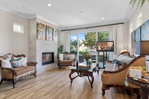 Smart TV, fireplace, books, computer monitors