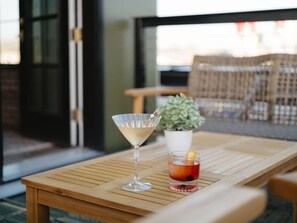 A wooden table with a martini glass and a cocktail on it. - Perfect for Couples-Walk Everywhere-Luxe Apt (Rogers)