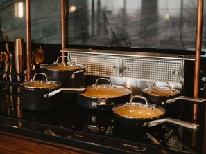 A kitchen with four pots on a stove. - Perfect for Couples-Walk Everywhere-Luxe Apt (Rogers)