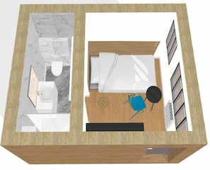 Une chambre d’hôtel avec deux lits, une salle de bain, un bureau et une chaise.