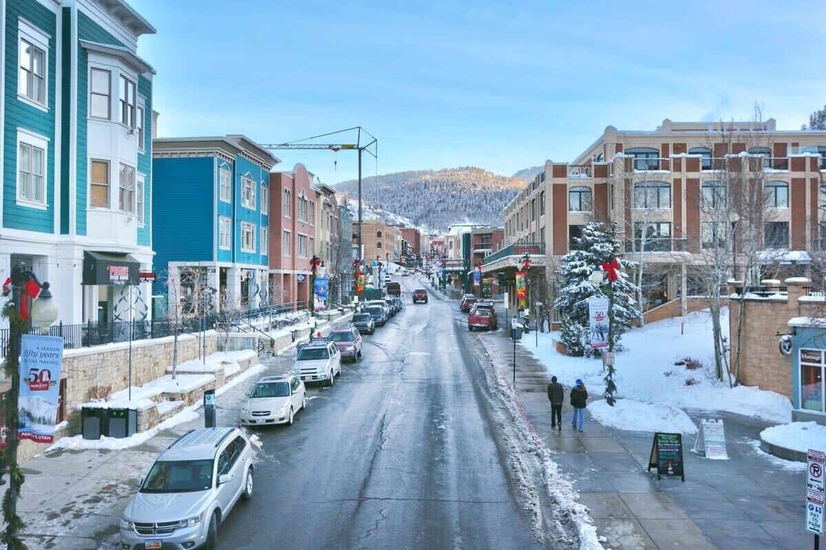 A street lined with multi-story buildings, some with commercial establishments on the ground floor.