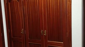A large wooden wardrobe with multiple doors and handles.