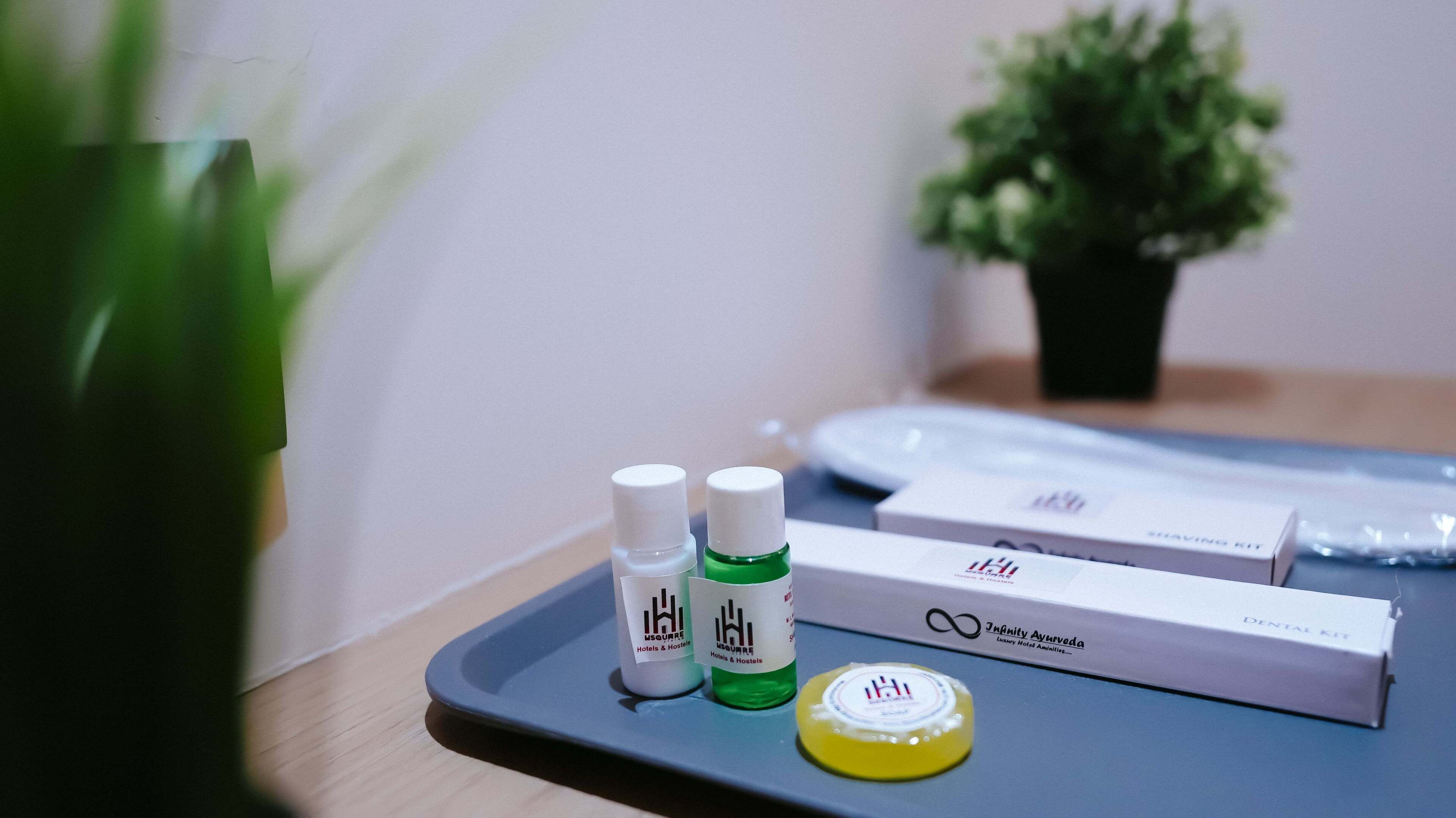 A tray with a dental kit, two bottles, and a green liquid bottle.