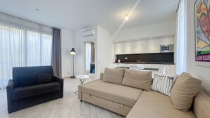 A modern living room with a sofa, a coffee table, and a floor lamp.