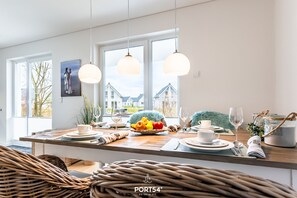 Enjoy meals in a beautifully set dining area with a large window offering a view of the surrounding neighborhood.