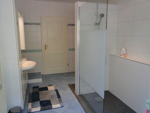 Shower, hair dryer, towels, toilet paper