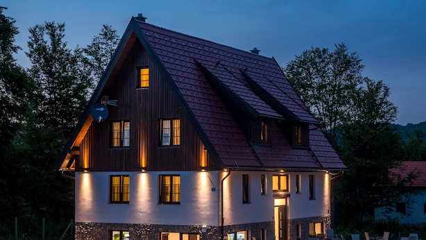 A two-story house with a sloped roof, stone foundation, and multiple windows. - B&B Plitvice Queen (Plitvicka Jezera)
