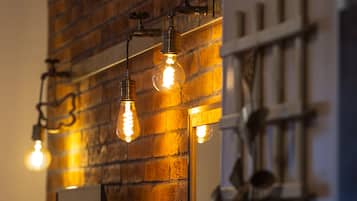 A wall with exposed brick and hanging light fixtures.