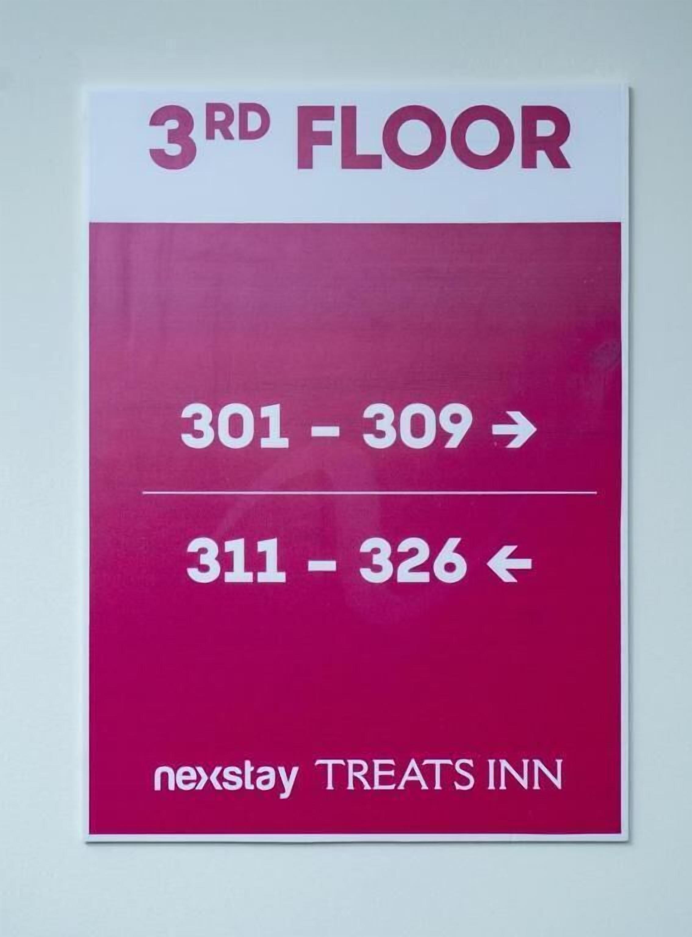 A sign indicating the 3rd floor of the nextstay Treats Inn with room numbers 301-309 to the right and 311-326 to the left.