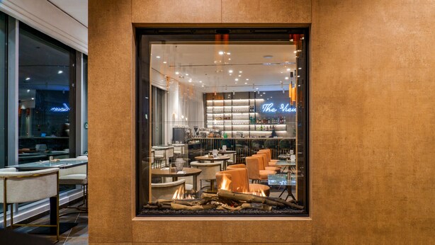A modern interior with a bar area, seating, and a fireplace. - Almond Hotel – Adults Only (Mateh Yehuda)