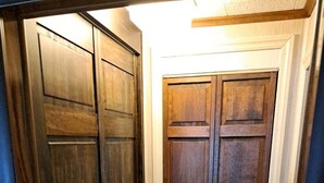 A hallway with a wooden double door and a carpeted floor. - On Long Lake with Direct Access to Trails-L & R Lakeside Rentals  (Sinclair)