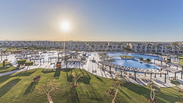 A resort with a large pool, sun loungers, and a well-maintained lawn. - SUNRISE Crystal Bay Resort - Posh Club (Hurghada)